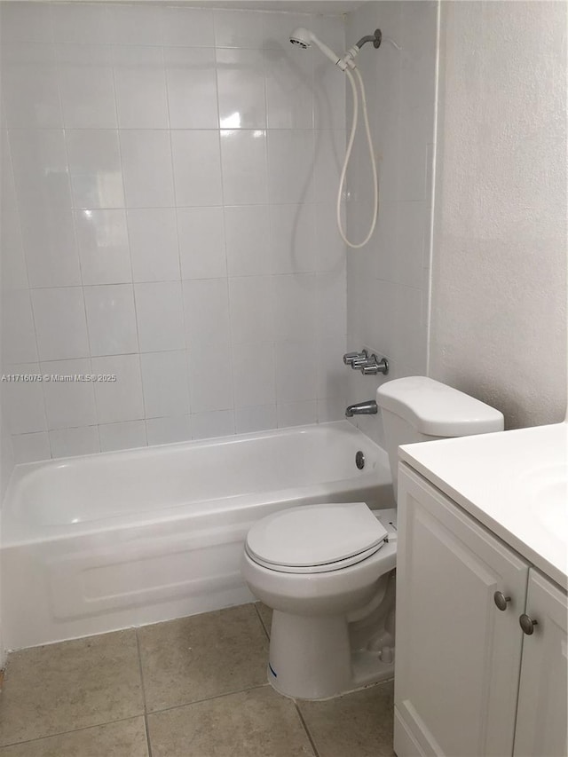 full bathroom featuring tile patterned flooring, vanity, toilet, and tiled shower / bath