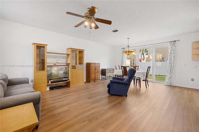 living room featuring light wood-type flooring and ceiling fan