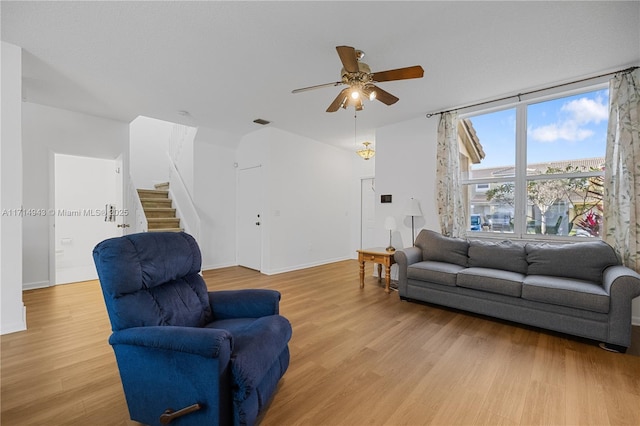 living room featuring light wood-type flooring and ceiling fan