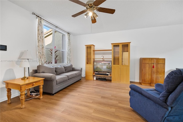 living room featuring ceiling fan and light wood-type flooring