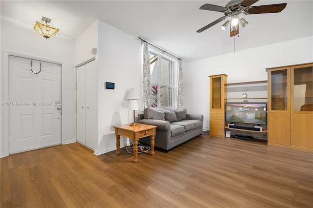 living room with ceiling fan and hardwood / wood-style floors