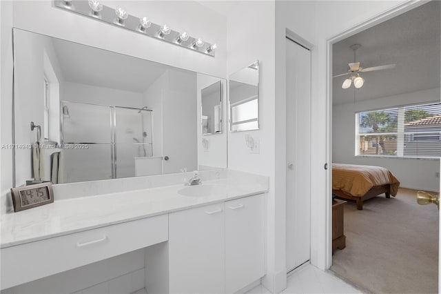 bathroom featuring ceiling fan, vanity, and a shower with shower door