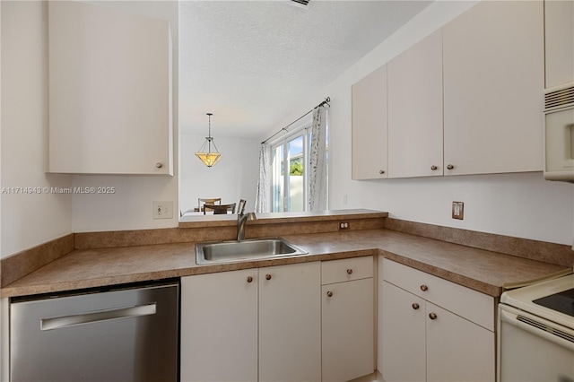 kitchen featuring decorative light fixtures, white cabinetry, white appliances, and sink