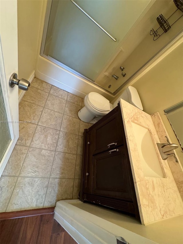 full bathroom featuring vanity, toilet, and combined bath / shower with glass door