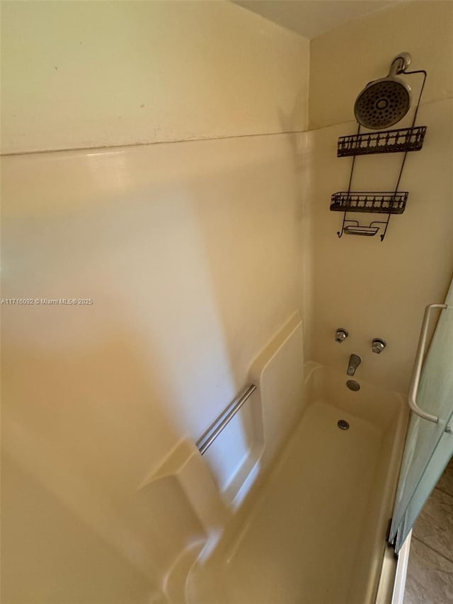 bathroom with washtub / shower combination