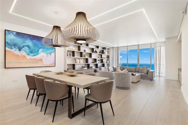 dining area with a water view and a wall of windows