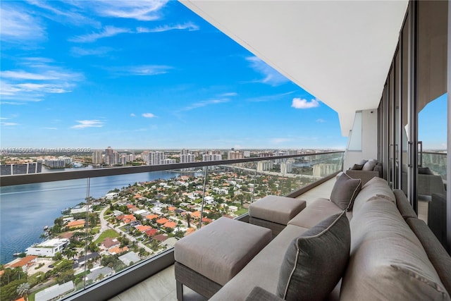 balcony with an outdoor living space and a water view