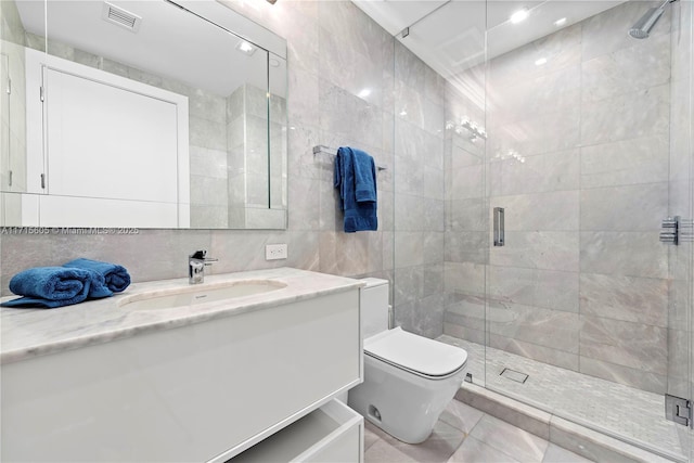 bathroom with tile walls, vanity, a shower with shower door, and toilet