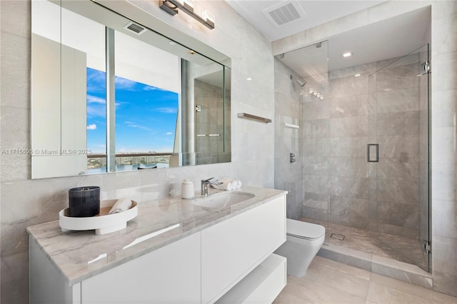 bathroom with an enclosed shower, toilet, and tile walls