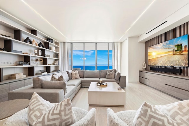 living room featuring light hardwood / wood-style flooring and a wall of windows