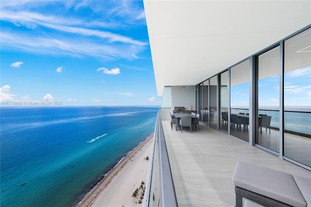 balcony with a water view and a beach view