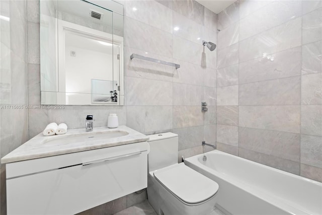 full bathroom featuring vanity, tile walls, shower / bathtub combination, and toilet