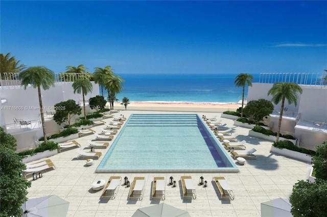 view of swimming pool featuring a water view, a beach view, and a patio