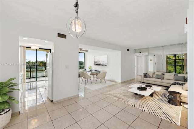 living room featuring plenty of natural light, ceiling fan, and light tile patterned floors