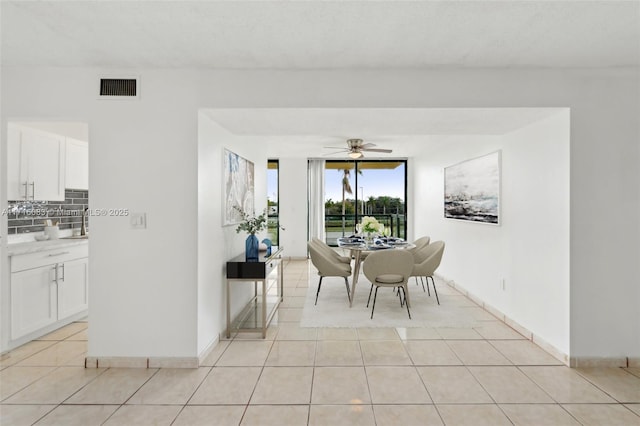 tiled dining room featuring ceiling fan