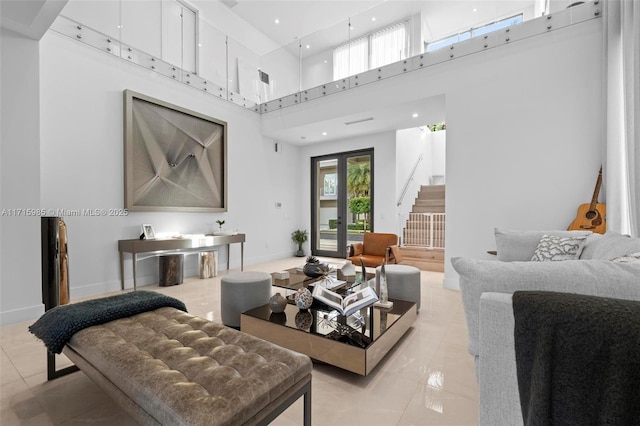 living room featuring french doors, a towering ceiling, and light tile patterned floors