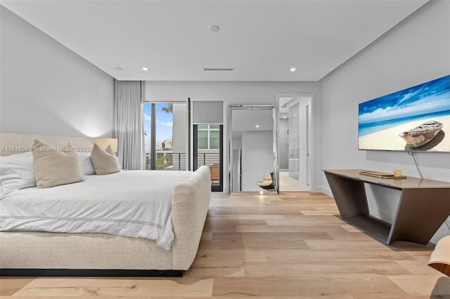 bedroom featuring access to outside and light hardwood / wood-style flooring