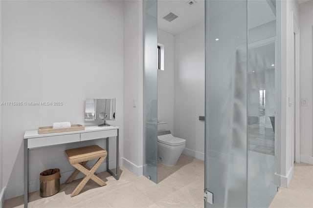 bathroom featuring an enclosed shower and toilet