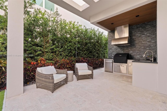 view of patio featuring an outdoor kitchen, a grill, and sink