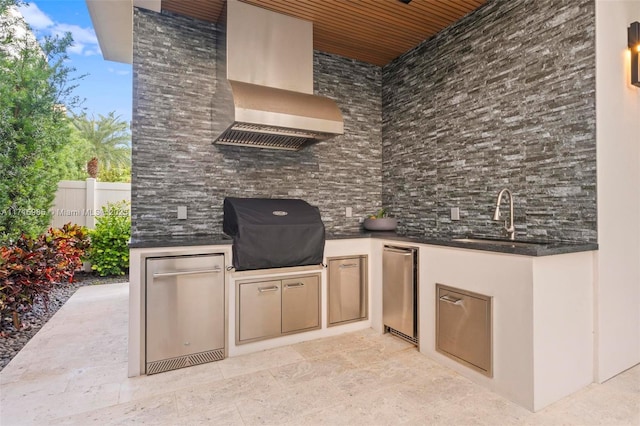 view of patio / terrace featuring sink, grilling area, and exterior kitchen