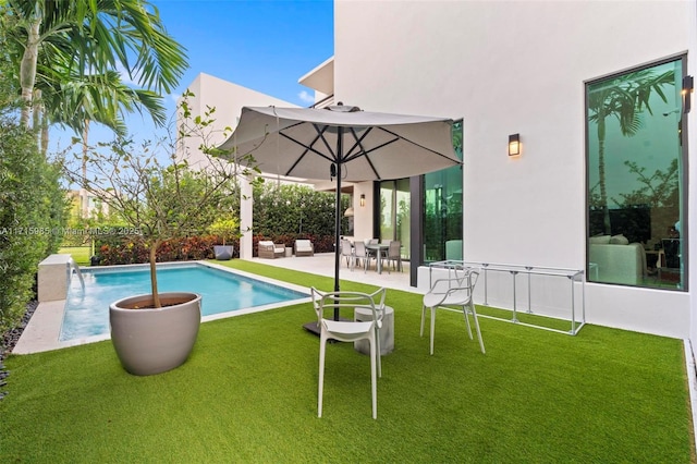 view of swimming pool with a patio and a lawn