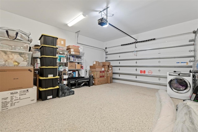 garage with a garage door opener and washer / clothes dryer