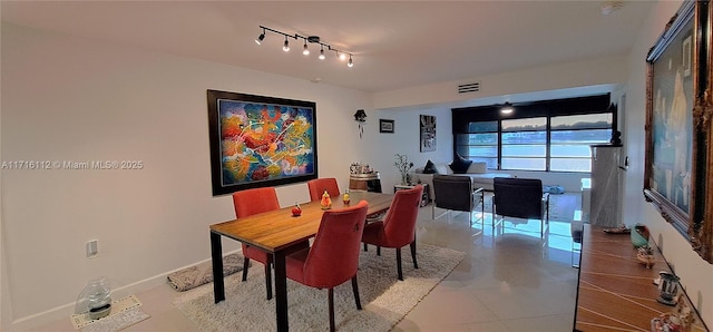 tiled dining space with rail lighting