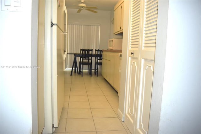 hall featuring light tile patterned floors