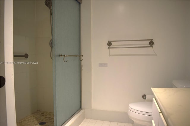 bathroom featuring vanity, toilet, and a shower with door