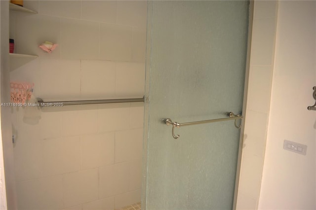 bathroom featuring a shower with door