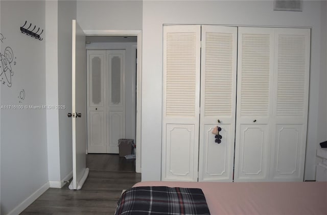 bedroom featuring a closet and dark hardwood / wood-style floors