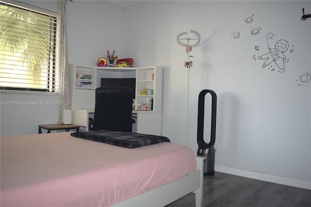 bedroom with dark hardwood / wood-style flooring