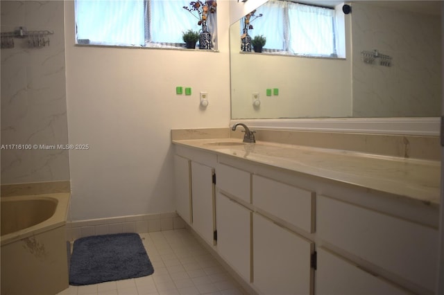 bathroom featuring tile patterned floors, a tub, and vanity