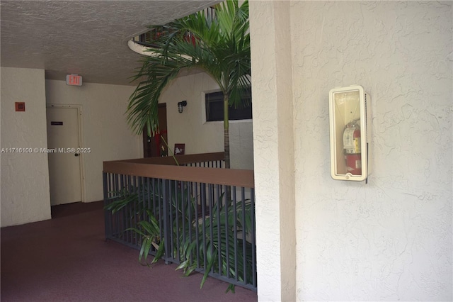 corridor with a textured ceiling