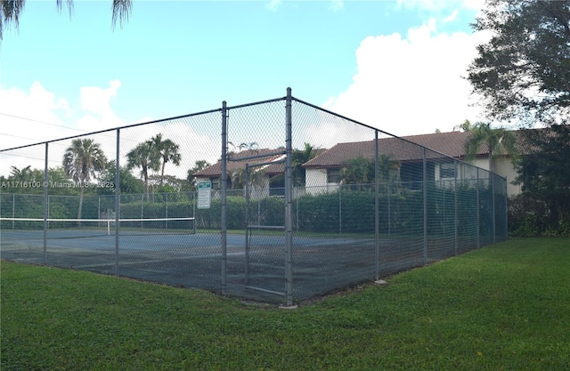 view of sport court with a yard