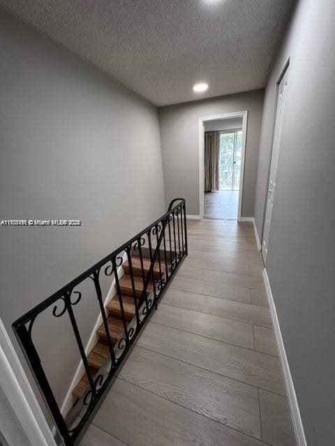 stairway with a textured ceiling