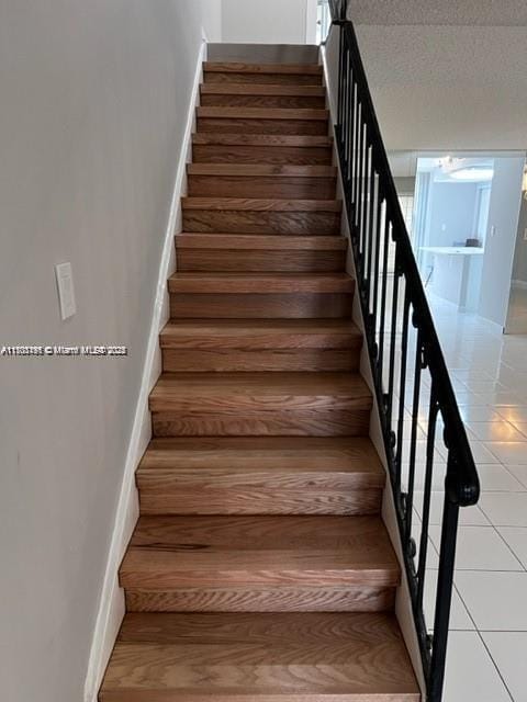 stairs with tile patterned flooring