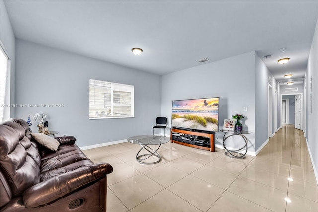 tiled living room with a healthy amount of sunlight