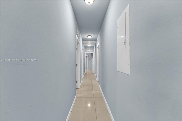 hallway featuring light tile patterned floors and electric panel