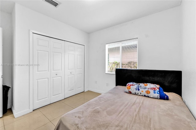 bedroom featuring a closet and light tile patterned flooring