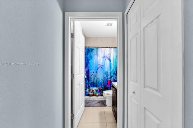 corridor featuring light tile patterned floors