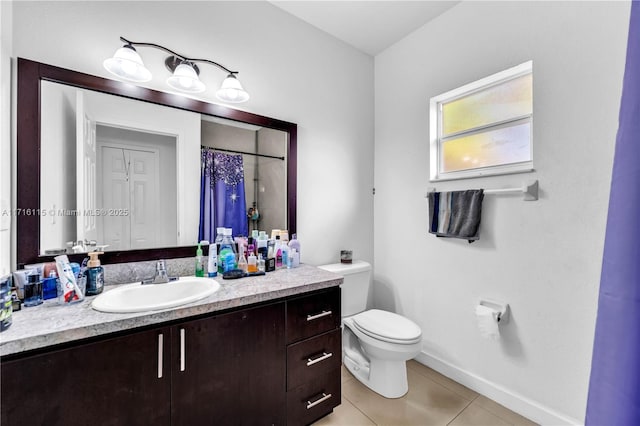 bathroom featuring tile patterned floors, vanity, and toilet