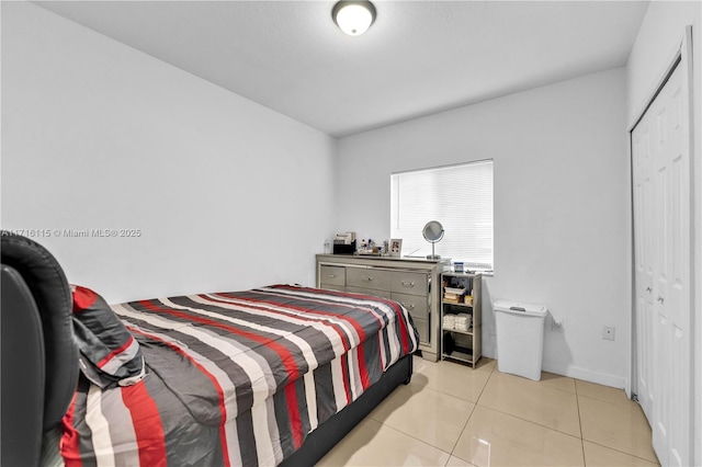 tiled bedroom featuring a closet