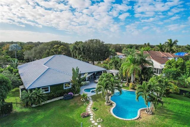 view of pool with a yard