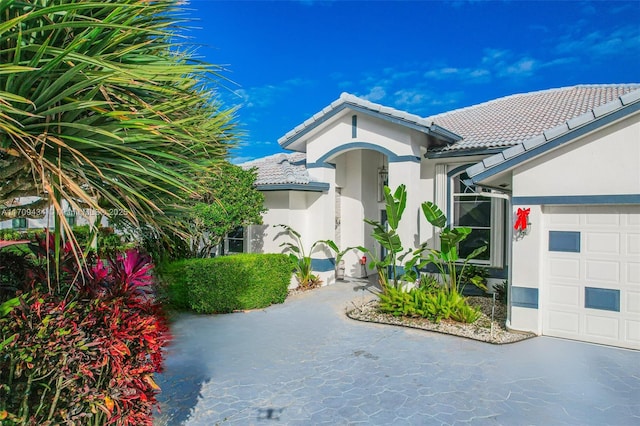 mediterranean / spanish-style house with a garage