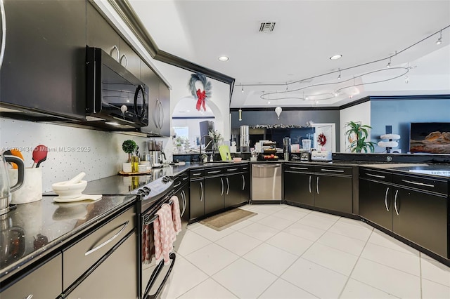 kitchen featuring backsplash, sink, light tile patterned floors, and black appliances