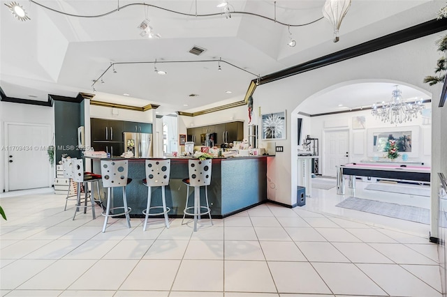 kitchen with ornamental molding, stainless steel fridge with ice dispenser, and light tile patterned floors