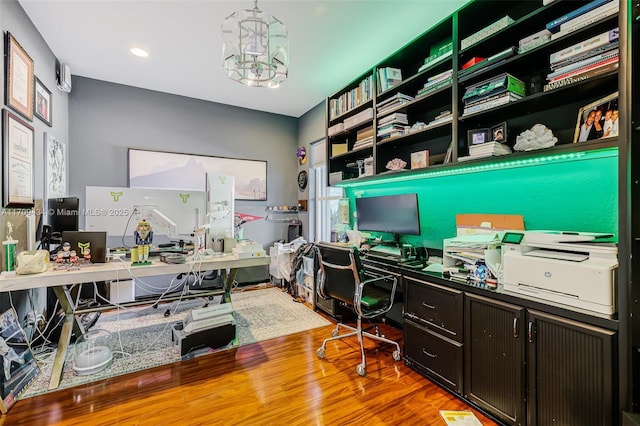 office space with wood-type flooring and a chandelier