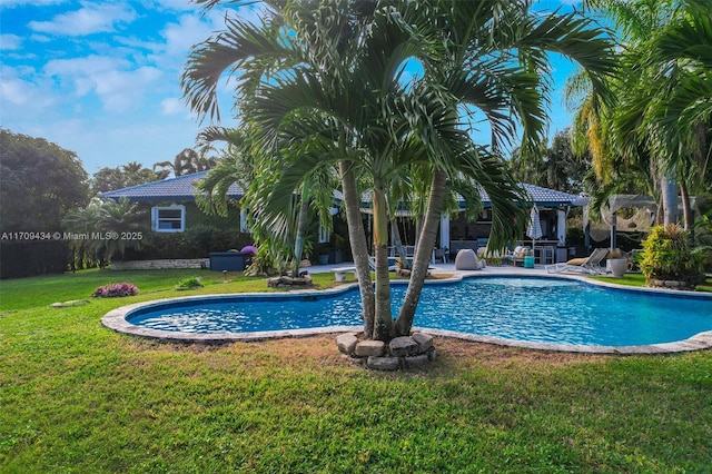 view of pool featuring a lawn