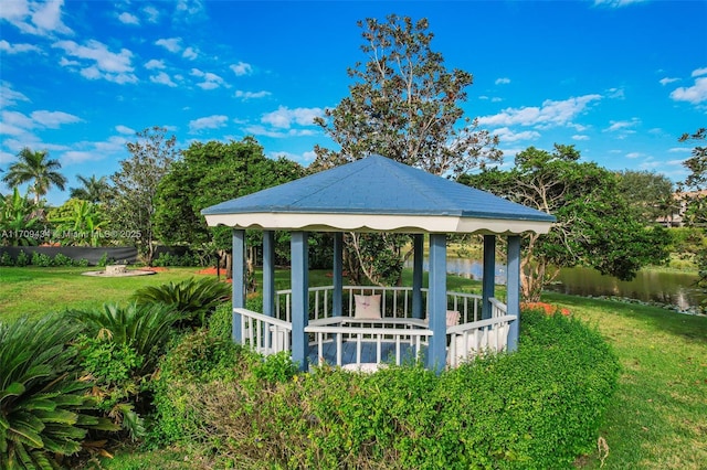 exterior space with a gazebo, a water view, and a lawn